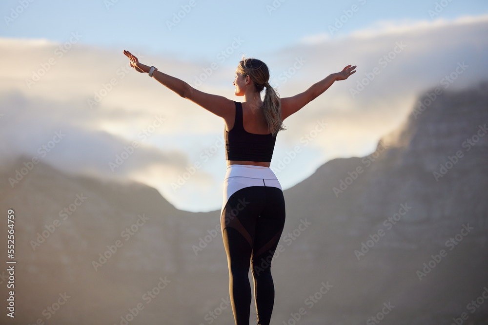 Freedom, fitness and woman in nature by mountain spreading hands wide open. Open arms, peace and female relax outdoors on break enjoying view after running, exercise or training, hike or workout.