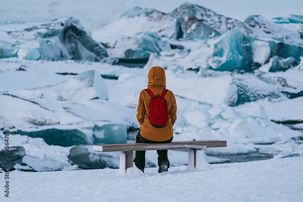 sitting woman watching the impressive glacier