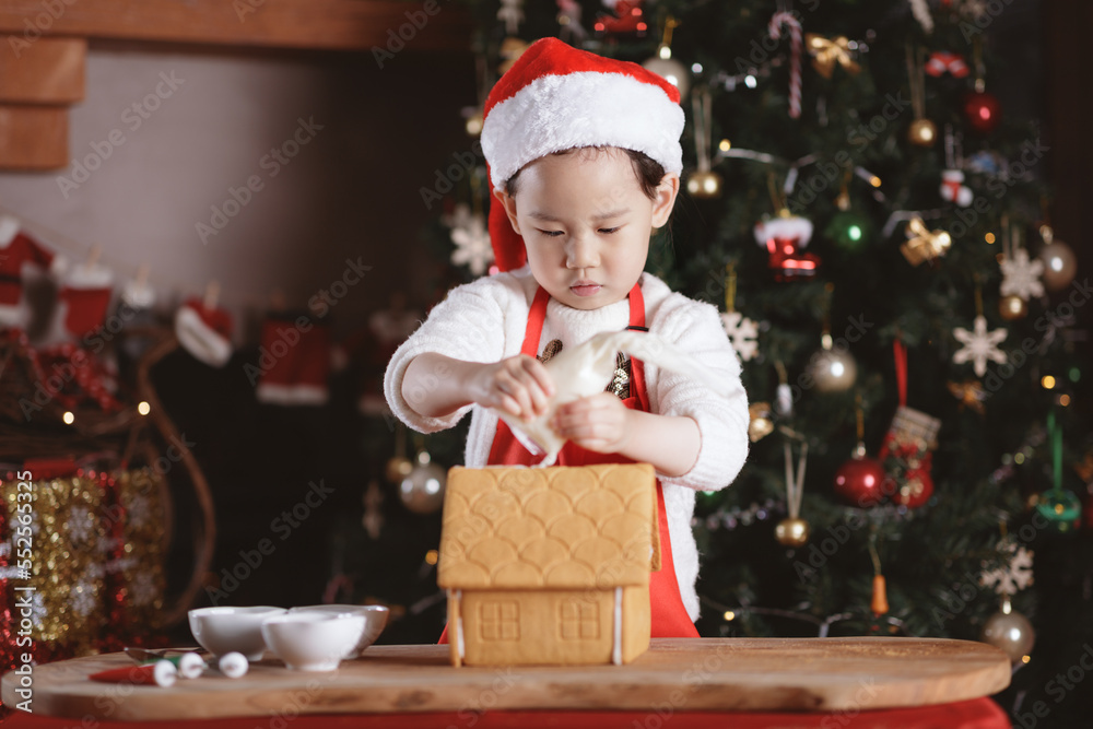 young girl making gingerbread house at home young girl making gingerbread house at home