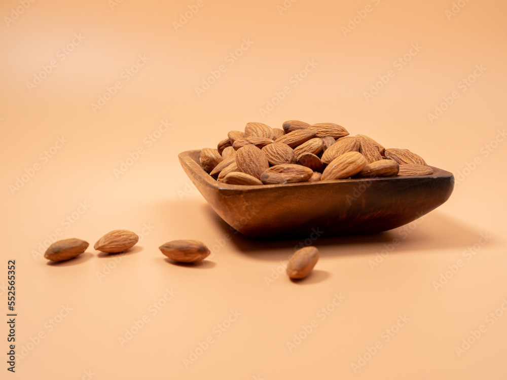 Almond nut on an orange background. Raw almond.