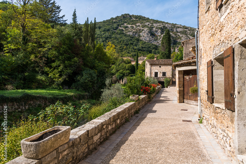 Walkway and landscape at the edge of the historic French village of Saint-Guilhem-le-Desert