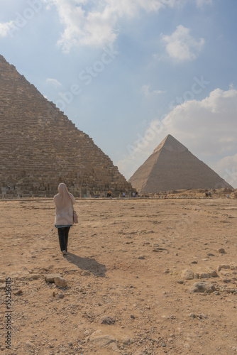 woman walks in the pyramids of Giza in Egypt