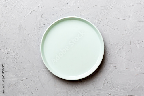 Top view of empty blue plate on cement background. Empty space for your design