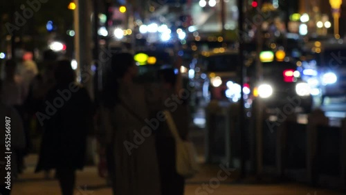 OSAKA, JAPAN -SEP 2022 : Back shot of crowd of people walking at business district near Osaka station at night. Busy street traffic background. Japanese city lifestyle concept video. Time lapse shot. photo