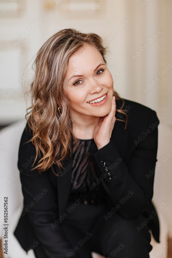 an attractive, feminine and confident woman in a black suit. an attractive, feminine and confident woman in a black suit.