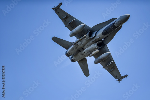 Military supersonic fighter jet with blue sky in the background