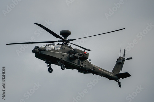 close up of a British army AH-64E Boeing Apache Attack helicopter (ZM722 ArmyAir606) on landing approach, autumn sky