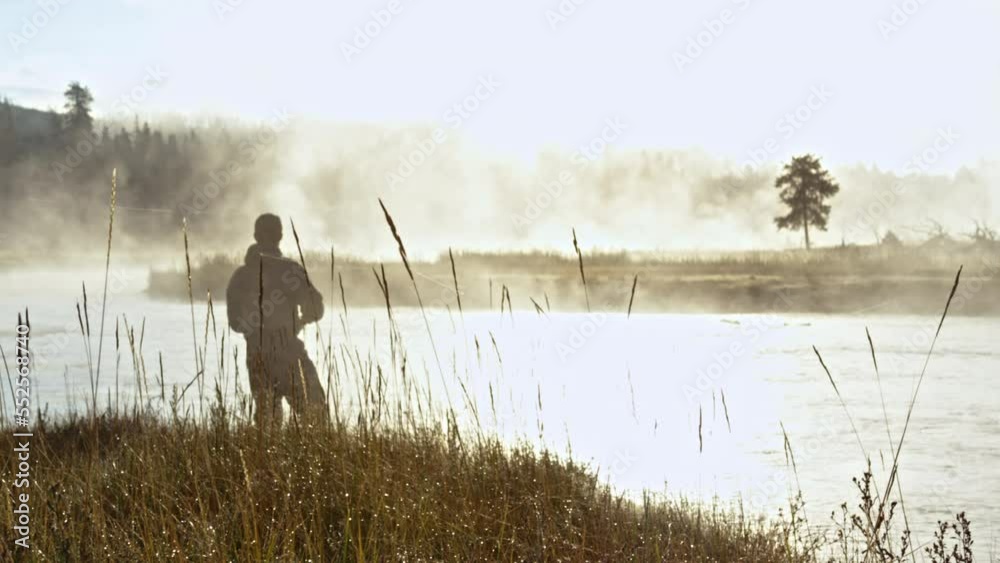 Slowmotion shot of a fly fisherman letting line out and getting ready to cast Slowmotion shot of a fly fisherman letting line out and getting ready to cast
