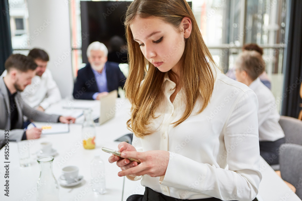 Fototapeta premium Trainee reads SMS or checks news on smartphone