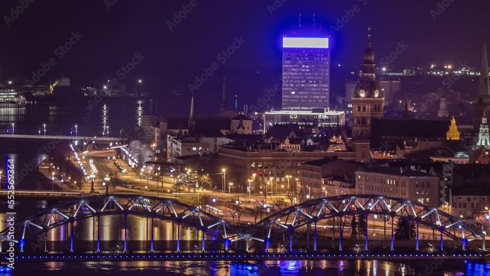 Time lapse shot of traffic along river in lighting city of Riga at night,Latvia - wide shot Time lapse shot of traffic along river in lighting city of Riga at night,Latvia - wide shot