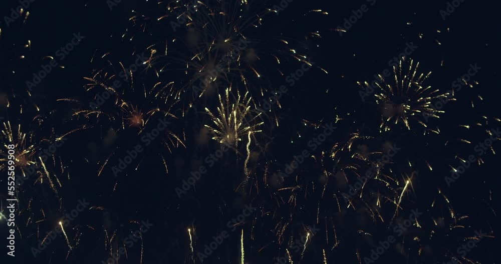Loop seamless of real fireworks background with bokeh lights in the night sky. New year's eve fireworks celebration. 4KDCI