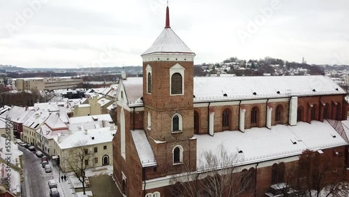 Kaunas Cathedral Basilica building covered with snow, aerial drone fly towards view photo