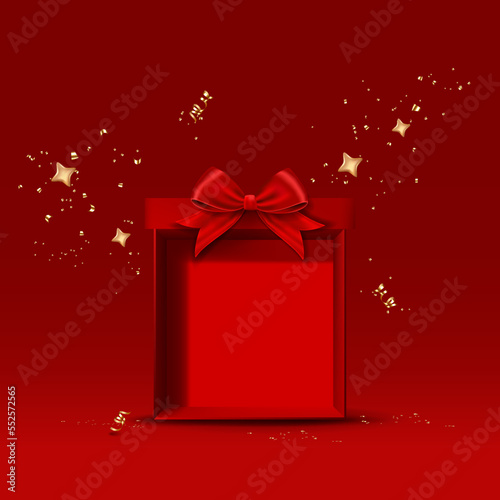 Open red gift box with red bow, stars, ribbon and confetti.