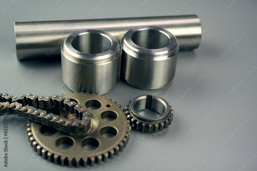 Steel turning and milling parts and gears on a dark background. Metal production Steel turning and milling parts and gears on a dark background. Metal production