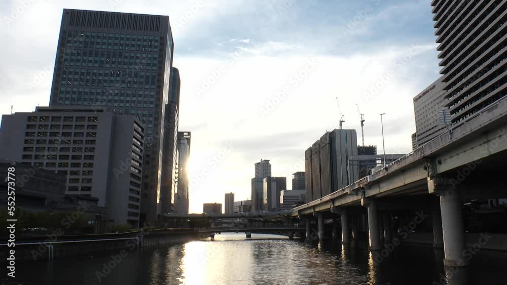 OSAKA, JAPAN - SEP 2022 : View of office buildings near Osaka station, high way and Dojima river in sunset. Time lapse shot, dusk to night. Japanese business, real estate and urban city concept video. OSAKA, JAPAN - SEP 2022 : View of office buildings near Osaka station, high way and Dojima river in sunset. Time lapse shot, dusk to night. Japanese business, real estate and urban city concept video.