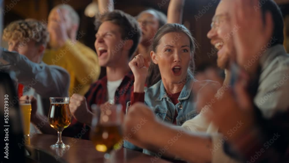 Portrait of a Beautiful Female Sitting at a Pub Counter with Group of Diverse Friends, Watching and Cheering for a Live Soccer Match. Supportive Fans Cheering, Applauding, Shouting and Drinking Beer.