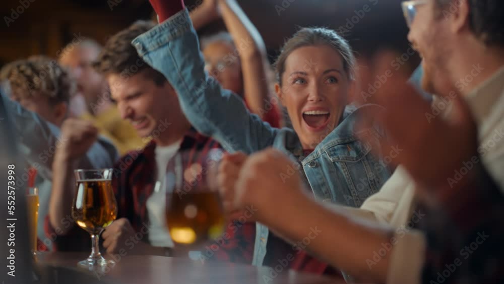 Excited Beautiful Female Sitting at a Bar Stand with Group of Friends, Cheering for a Soccer Team Playing in Tournament. Supportive Fans Applauding, Raising and Shouting in a Sports Pub.