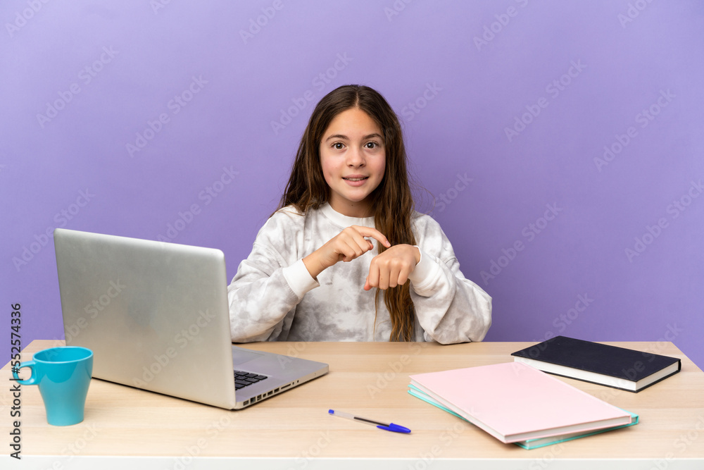 Little student girl in a workplace with a laptop isolated on purple background making the gesture of being late Little student girl in a workplace with a laptop isolated on purple background making the gesture of being late