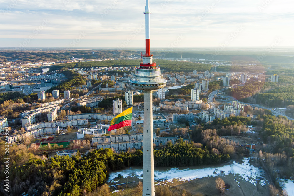 Fototapeta premium Giant tricolor Lithuanian flag waving on Vilnius television tower on the celebration of Restoration of the State Day.