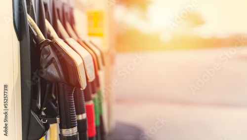 Colorful petrol and diesel nozzles of the dispenser machine at the gas fuel station Copy space