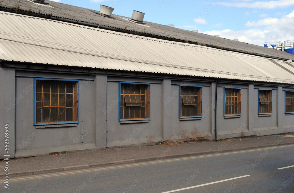 Single Storey Industrial Building with Corrugated Roof Beside Deserted Road