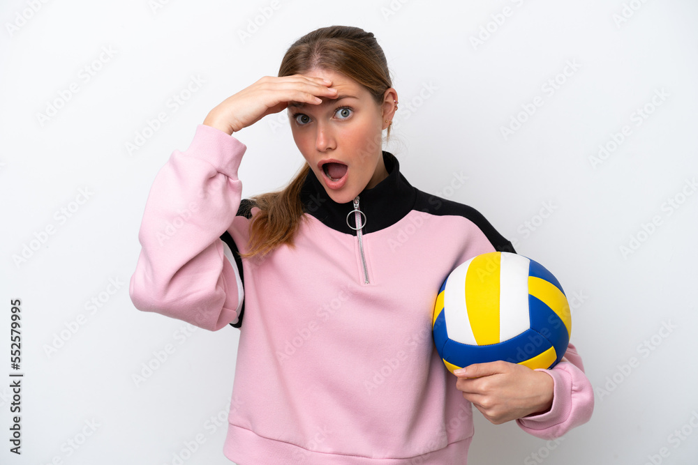 Young caucasian woman playing volleyball isolated on white background doing surprise gesture while looking to the side