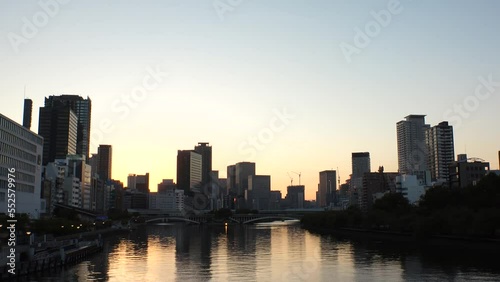 Wallpaper Mural OSAKA, JAPAN - SEP 2022 : Office buildings at Kitahama area and river in sunset. Large business district in Osaka. Time lapse shot, dusk to night. Japanese business, company and urban city concept. Torontodigital.ca