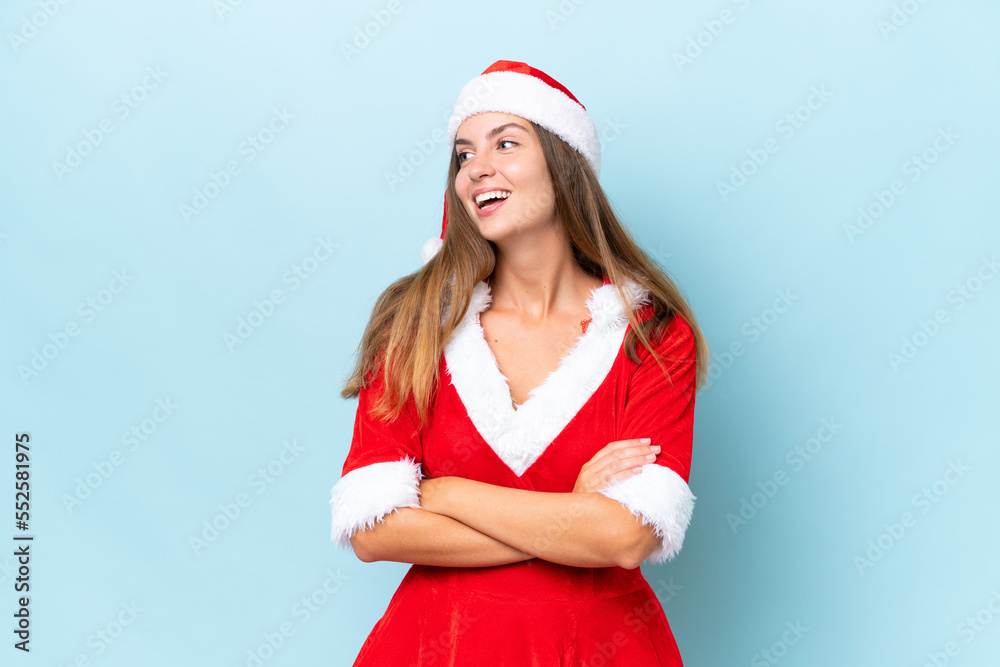 Young caucasian woman dressed as mama noel isolated on blue background happy and smiling Young caucasian woman dressed as mama noel isolated on blue background happy and smiling