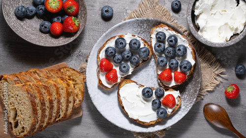Fresh breakfast with blueberry, strawberry and ricotta rye sandwiches
