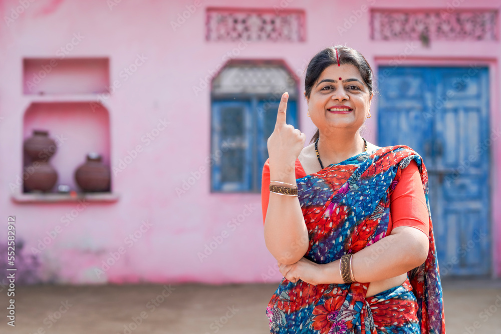 Indian women smiling and showing voting sign