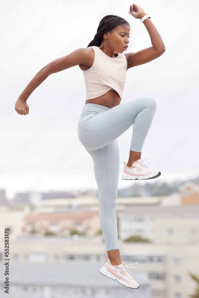 Black woman, jump and fitness while workout, exercise and training in  Brazil, city and body warm