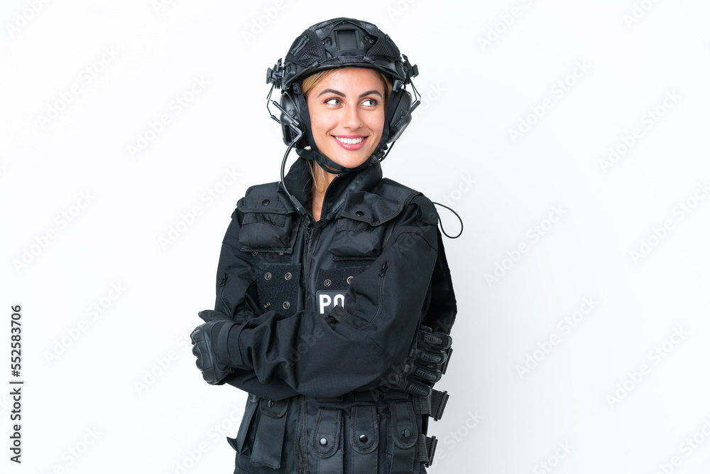 SWAT caucasian woman isolated on white background with arms crossed and happy