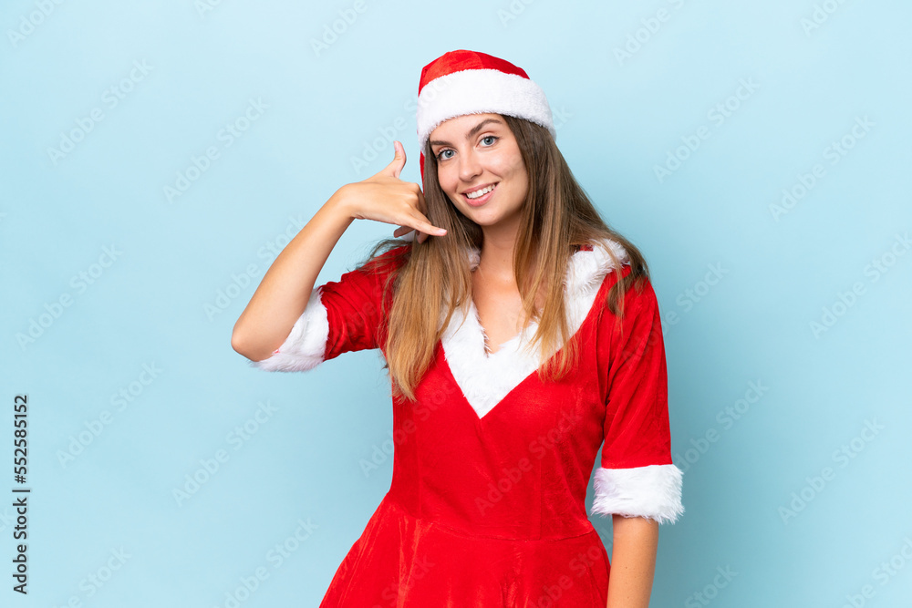 Young caucasian woman dressed as mama noel isolated on blue background making phone gesture. Call me back sign Young caucasian woman dressed as mama noel isolated on blue background making phone gesture. Call me back sign