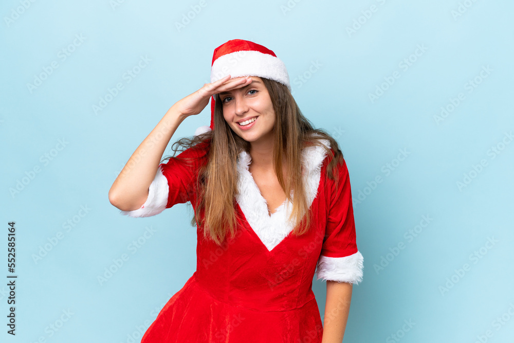 Young caucasian woman dressed as mama noel isolated on blue background looking far away with hand to look something Young caucasian woman dressed as mama noel isolated on blue background looking far away with hand to look something