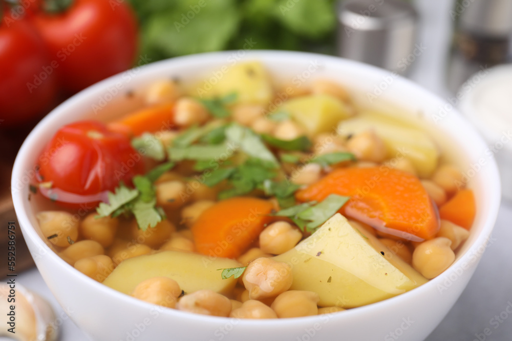 Tasty chickpea soup in bowl on table, closeup Tasty chickpea soup in bowl on table, closeup