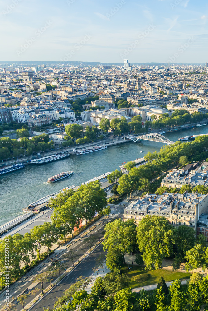 Aerial view of the Seine with some boats sailing on the river in Paris, France