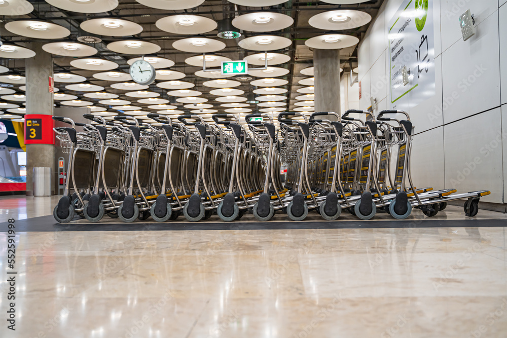 Baggage trolley grouped at the airport to serve traveling passengers