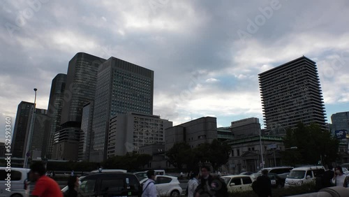 YODOYABASHI, OSAKA, JAPAN - SEP 2022 : View of office buildings and street traffic around Yodoyabashi business district. Long time lapse shot, sunset to night. Japanese business concept video. photo