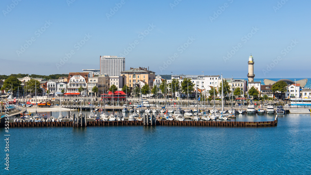 The yacht harbour, light tower and historic city centre of Warnemünde, Rostock in Germany on a clear summer day