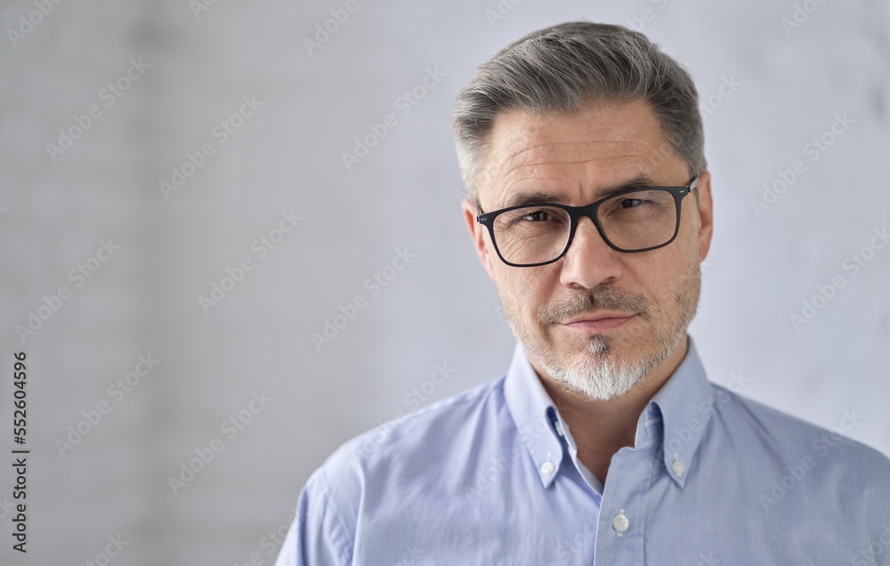 © nyul - Business portrait - confident middle aged businessman smiling. Happy mid adult older man with gray hair in glasses. Copy space . © nyul - Business portrait - confident middle aged businessman smiling. Happy mid adult older man with gray hair in glasses. Copy space .