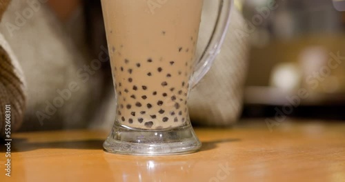 Stir with bubble milk tea in restaurant photo