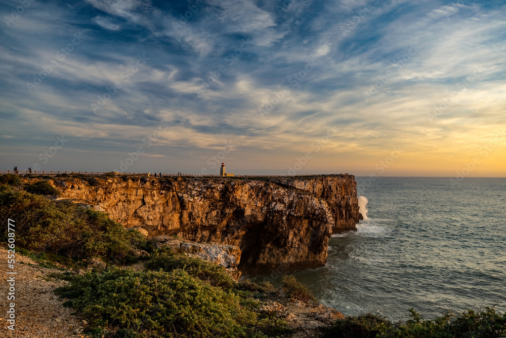 Przylądek Świętego Wincentego (port. Cabo de São Vicente) Portugalia, widok na latarnię morską na klifie, zachód słońca. 