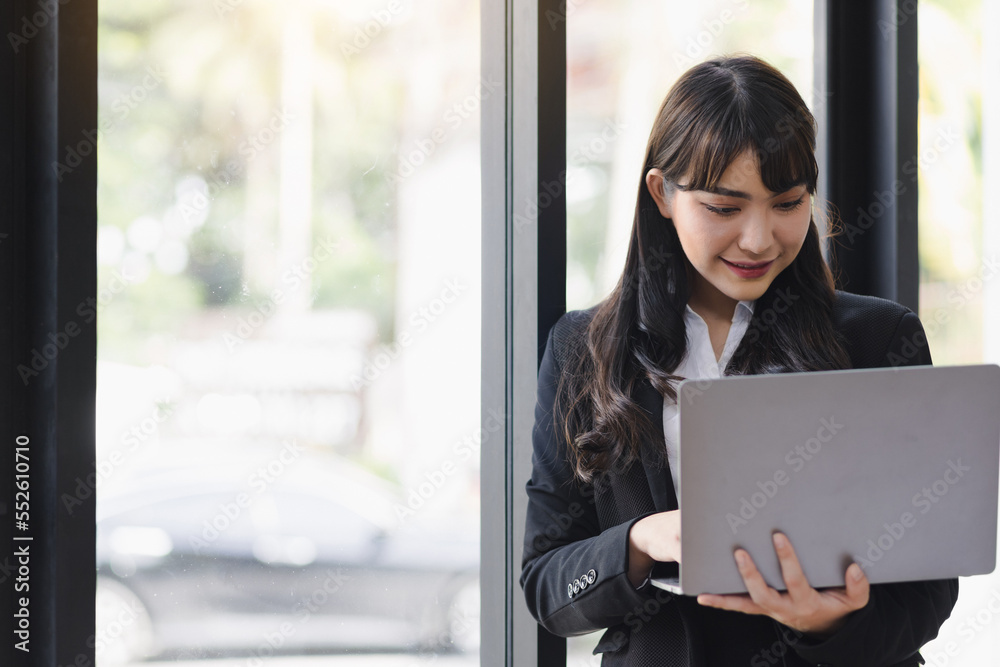 Portrait of a businesswoman holding a laptop working in the office. Portrait of a businesswoman holding a laptop working in the office.
