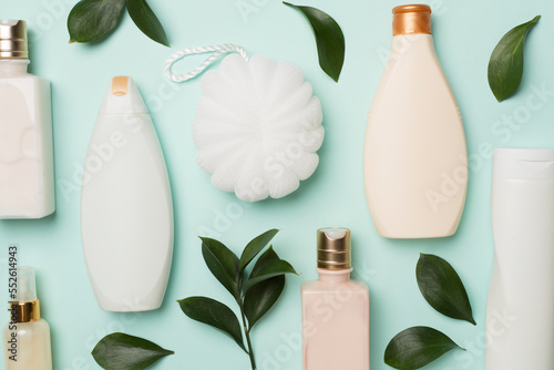 Cuadro en lienzo Different cosmetic bottles and washcloth on color background, top view