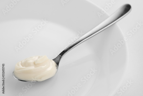 Mayonnaise. Spoon of homemade healthy mayonnaise sauce  soft cream. Healthy food ingredients. on white background. Dressing