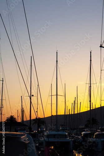 Fototapeta Naklejka Na Ścianę i Meble -  Close-up of yacht masts against the sunset sky. Marine theme
