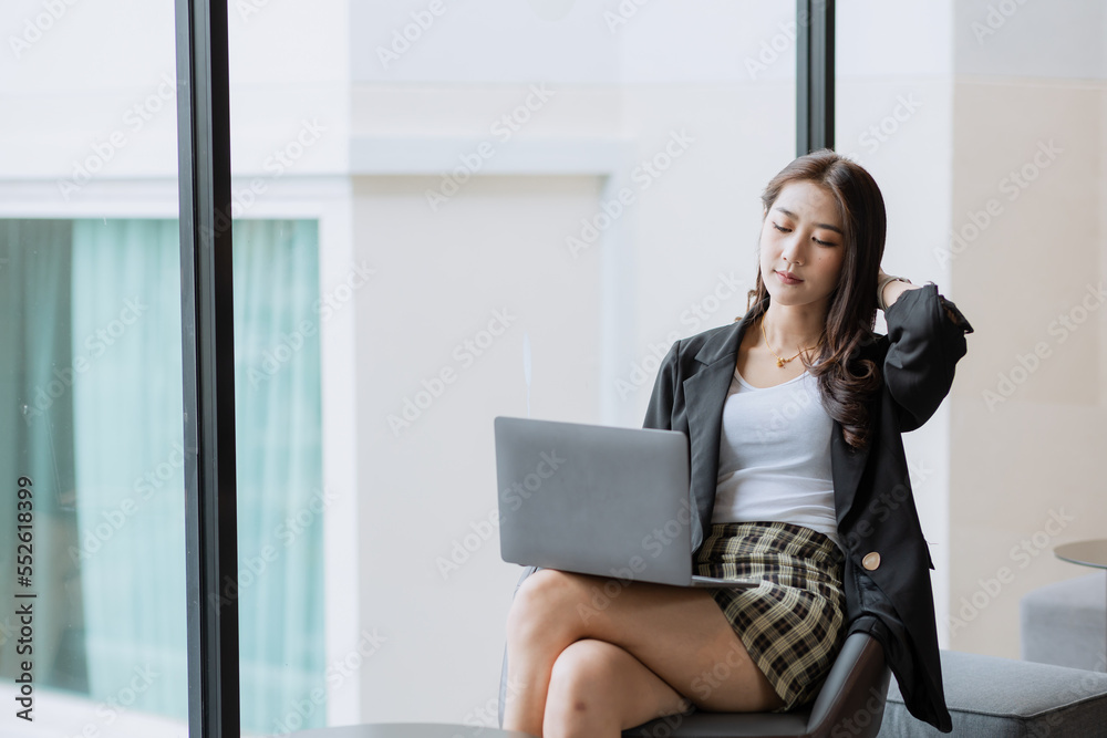 Pretty Asian woman using laptop in coffee shop Pretty Asian woman using laptop in coffee shop