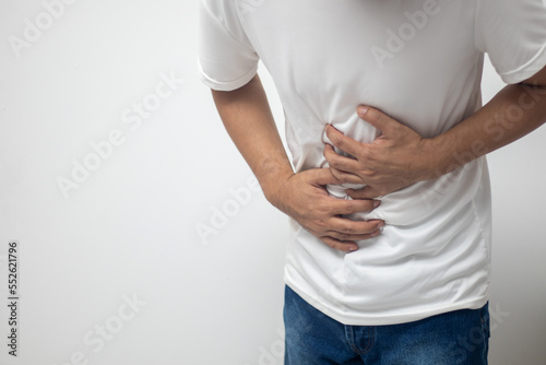 man having abdominal pain on white background