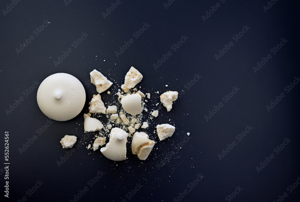 Broken meringue on a dark grey background Broken meringue on a dark grey background