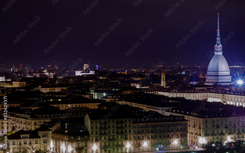 View of Turin by night from hill with Mole Antonelliana in background and Piazza Vittorio Veneto, Piazza Castello and the hills